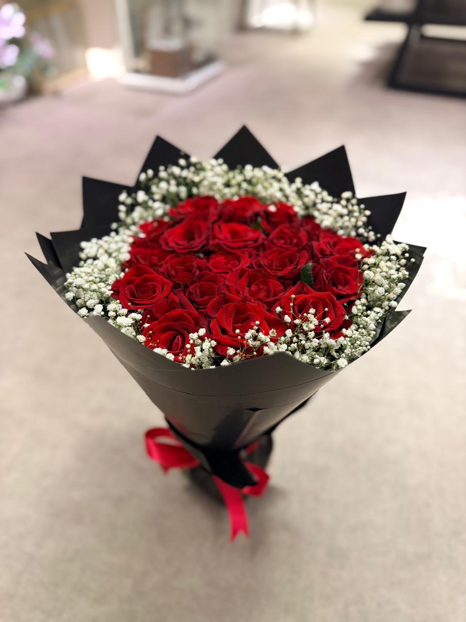 Red rose bouquet in black wrap